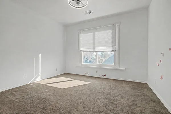 an empty room with a empty space and windows