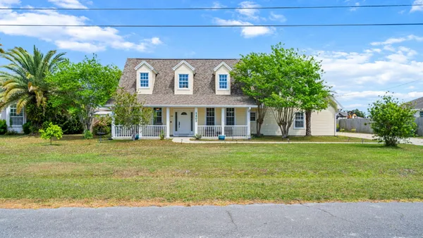 a front view of a house with a garden