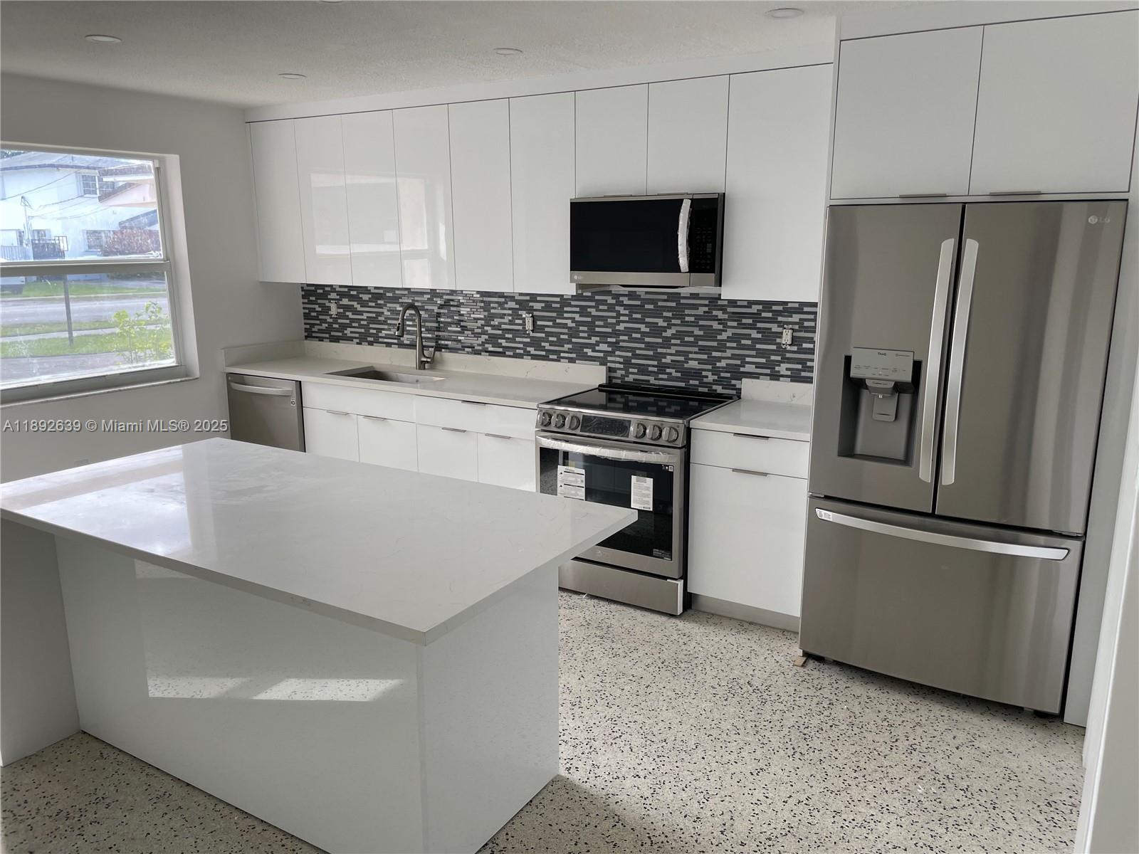 2250 Southwest 69th Avenue Miami, FL 33155 - Photo 4 of 14 a kitchen with stainless steel appliances a refrigerator sink and microwave
