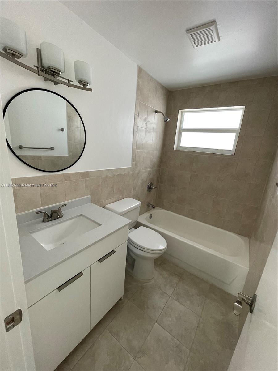 2250 Southwest 69th Avenue Miami, FL 33155 - Photo 7 of 14 a bathroom with a granite countertop toilet sink and mirror