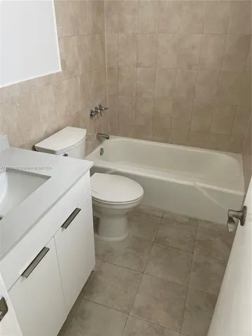 a bathroom with a sink a toilet and bathtub