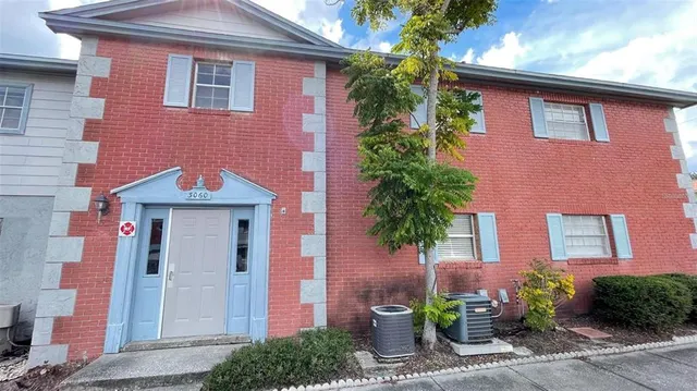 a front view of a house with plants