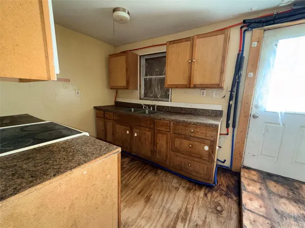 a kitchen with a stove a sink and a microwave
