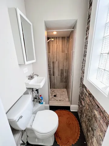 a bathroom with a sink a toilet and a mirror