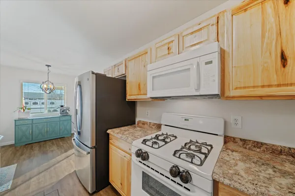 a kitchen with stainless steel appliances granite countertop a refrigerator stove and sink