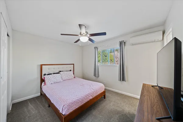 a bedroom with a bed and a window
