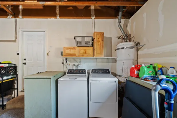 a utility room with dryer washer and storage