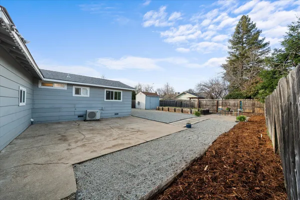 a view of a backyard with large trees