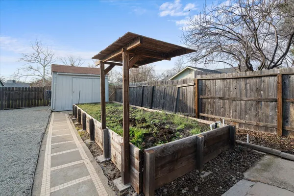 a view of a roof deck with wooden fence and a bench