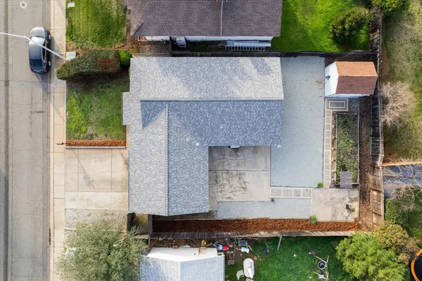 an aerial view of a house with swimming pool and patio