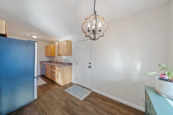 a kitchen with granite countertop white cabinets and stainless steel appliances