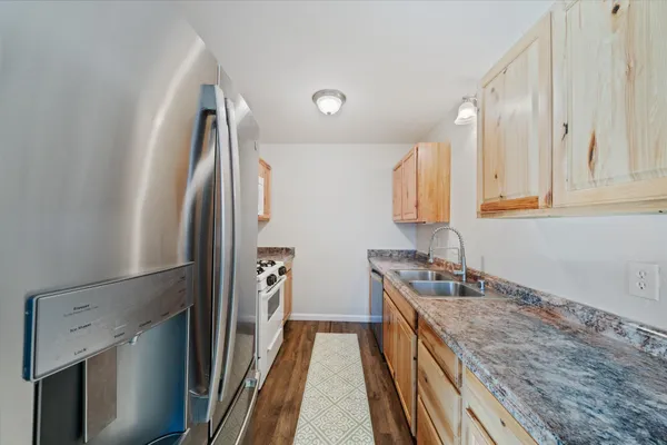 a kitchen with a sink and refrigerator
