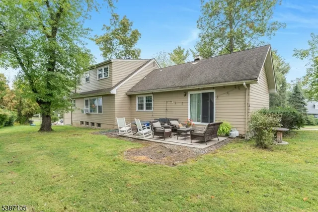 a backyard of a house with table and chairs