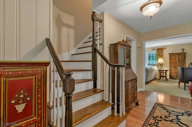 a view of a hallway with wooden floor and staircase