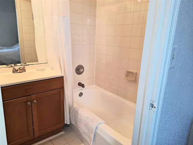 a bathroom with a bathtub a sink and a mirror