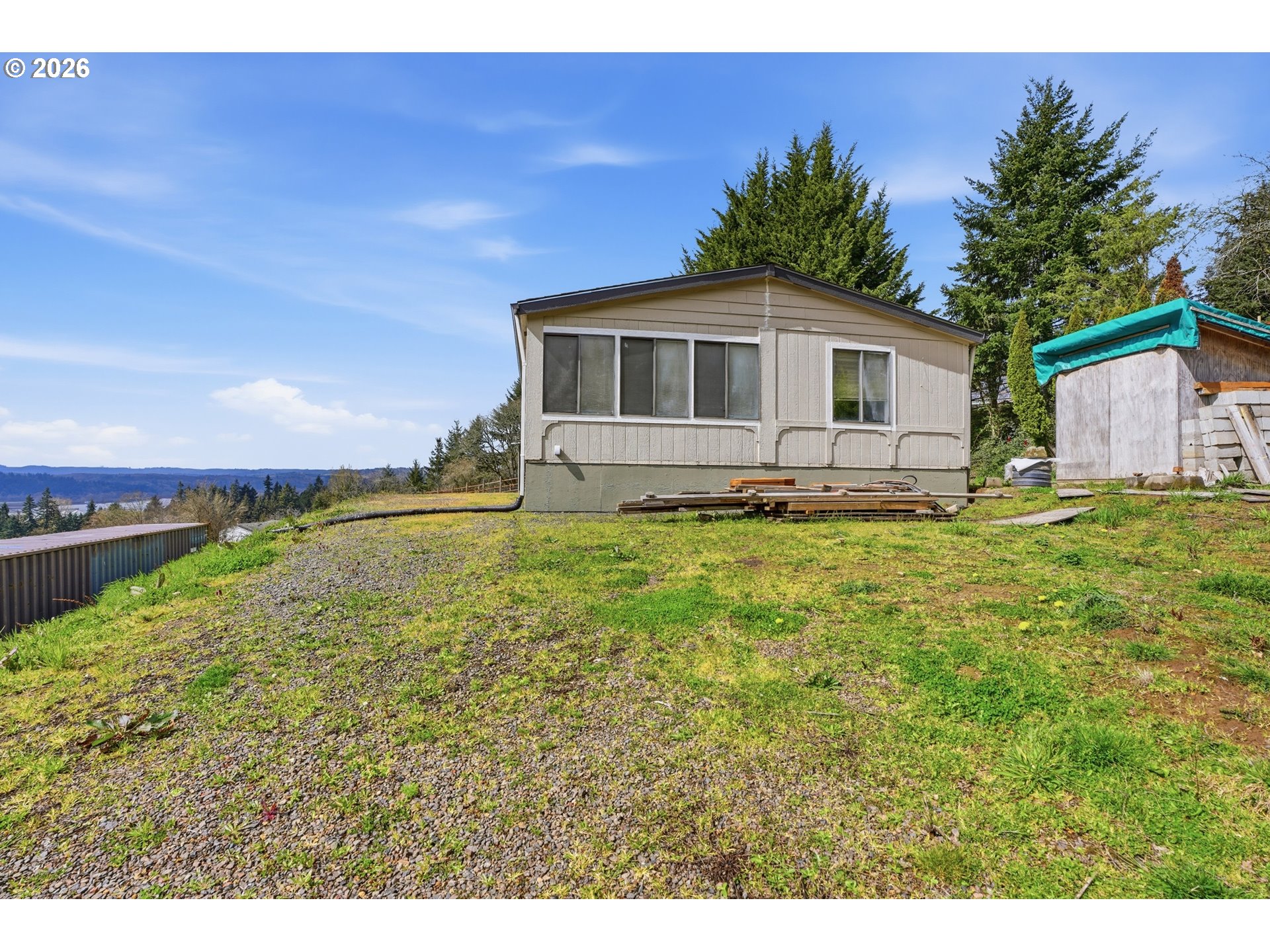 144 Angels Lane Kalama, WA 98625 - Photo 23 of 28 a large white house with a big yard and large trees