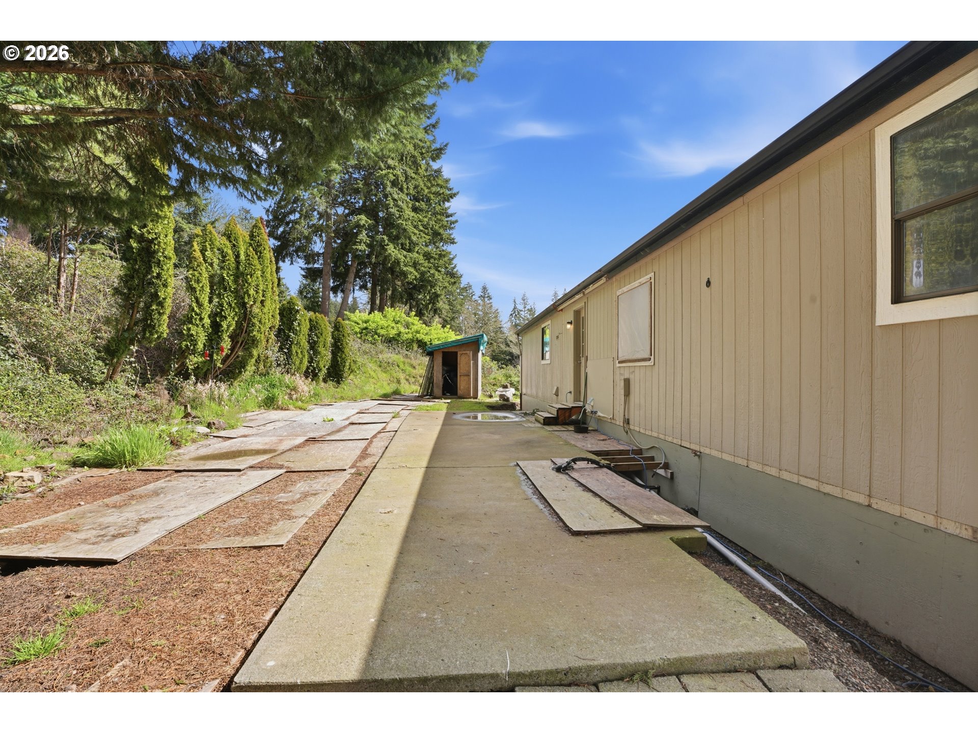 144 Angels Lane Kalama, WA 98625 - Photo 25 of 28 a view of a backyard with floor to ceiling window and wooden fence