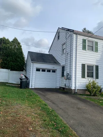 a view of a house with a yard and garage