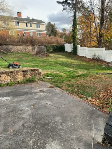 a view of a field with large trees