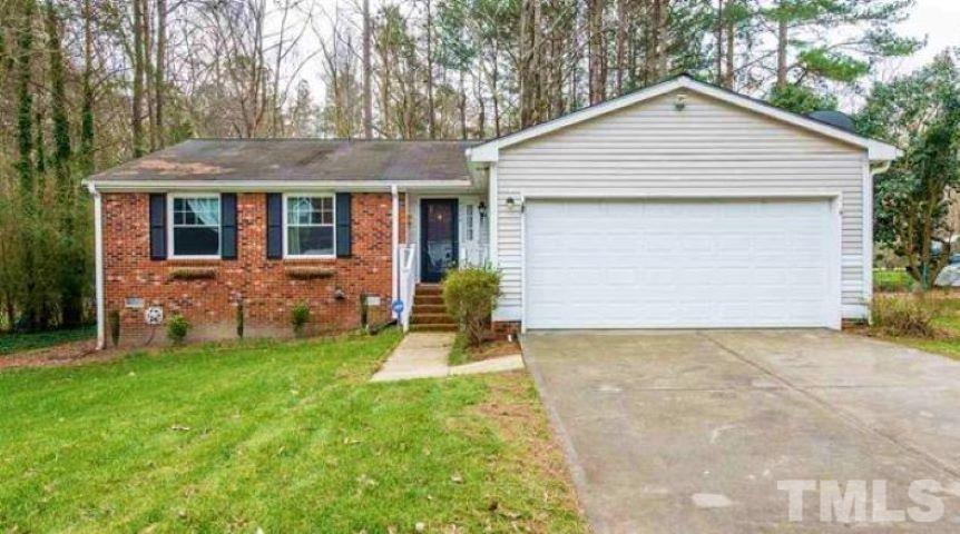 7216 Mine Shaft Road Raleigh, NC 27615 - Photo 1 of 3 a front view of house with yard and trees in the background