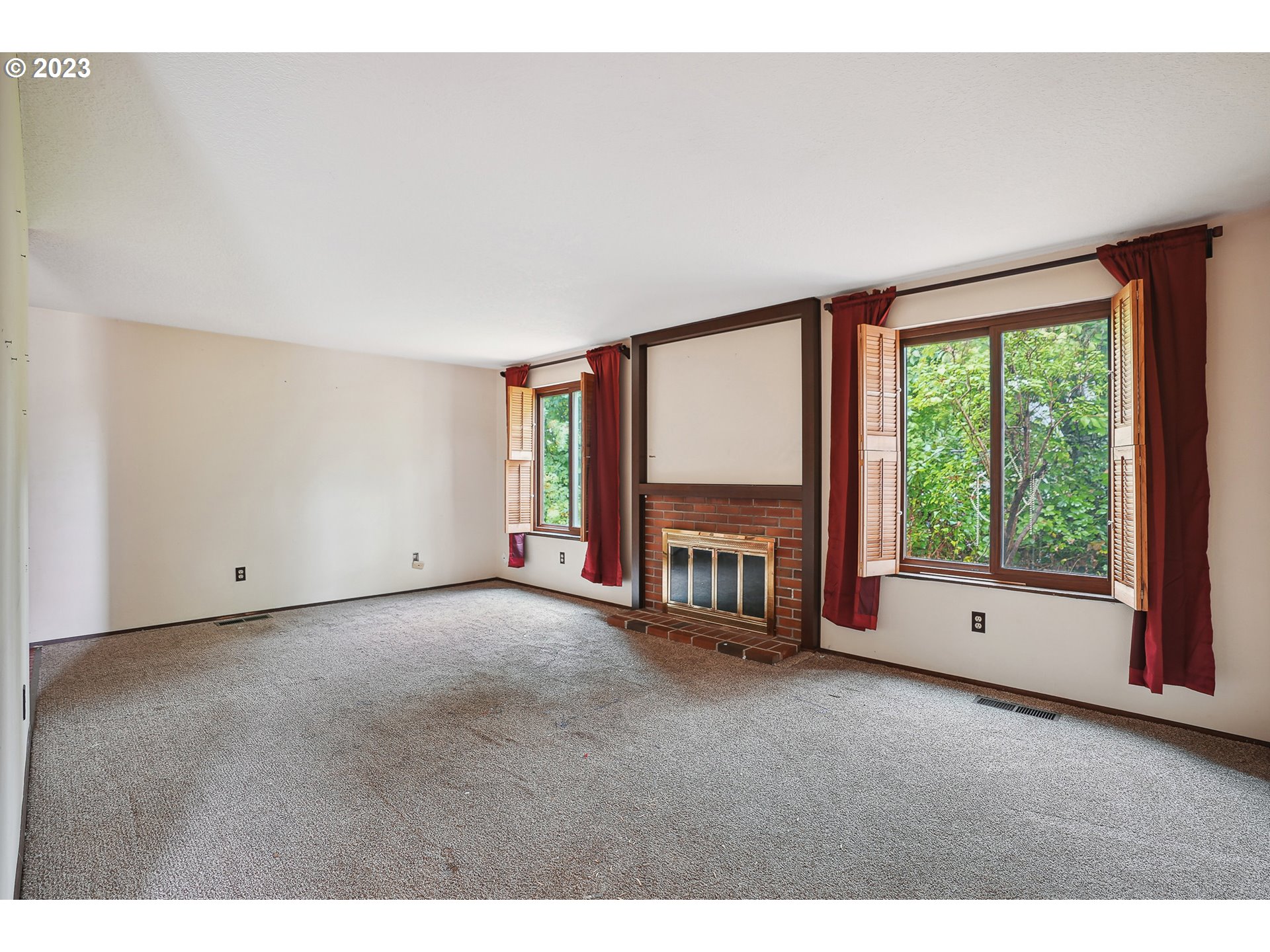 2295 Northeast Juniper Avenue Gresham, OR 97030 - Photo 5 of 25 a view of an empty room with a fireplace and a window