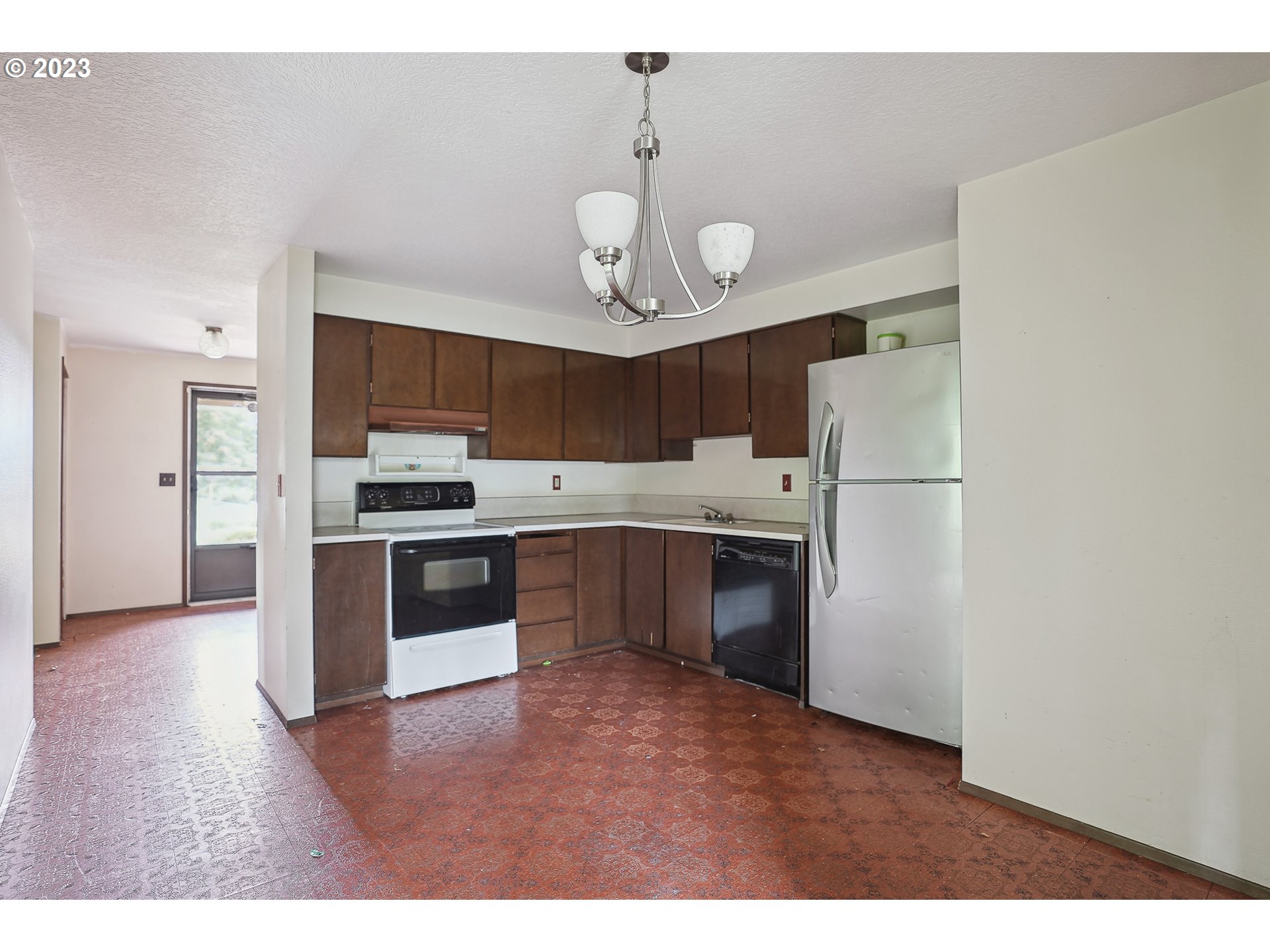 2295 Northeast Juniper Avenue Gresham, OR 97030 - Photo 7 of 25 a kitchen with stainless steel appliances a refrigerator and a stove top oven