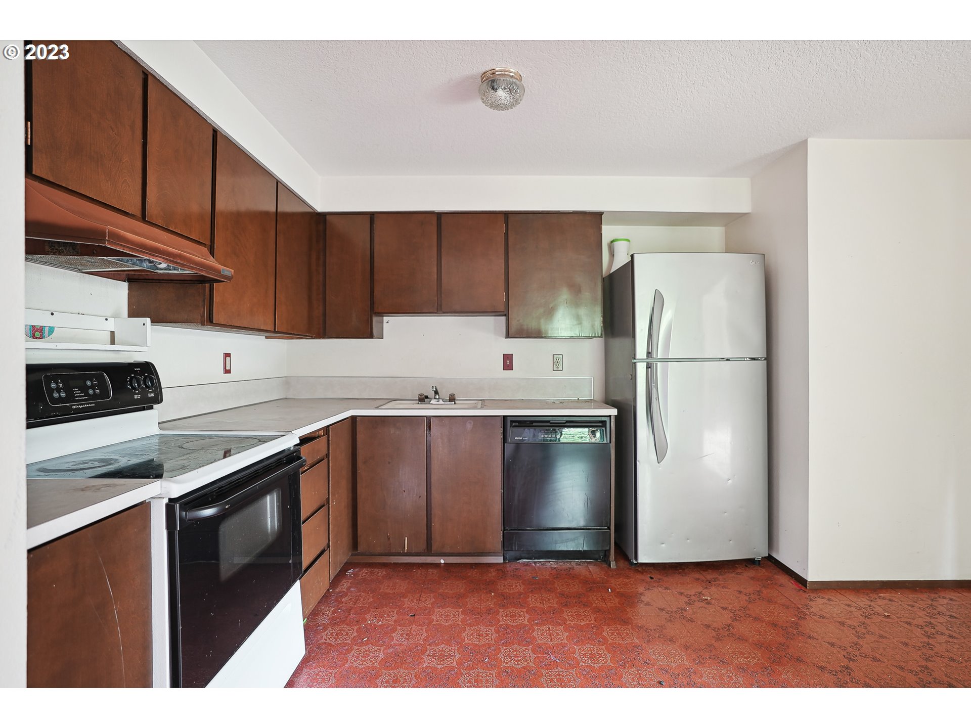 2295 Northeast Juniper Avenue Gresham, OR 97030 - Photo 8 of 25 a kitchen with a refrigerator sink and cabinets