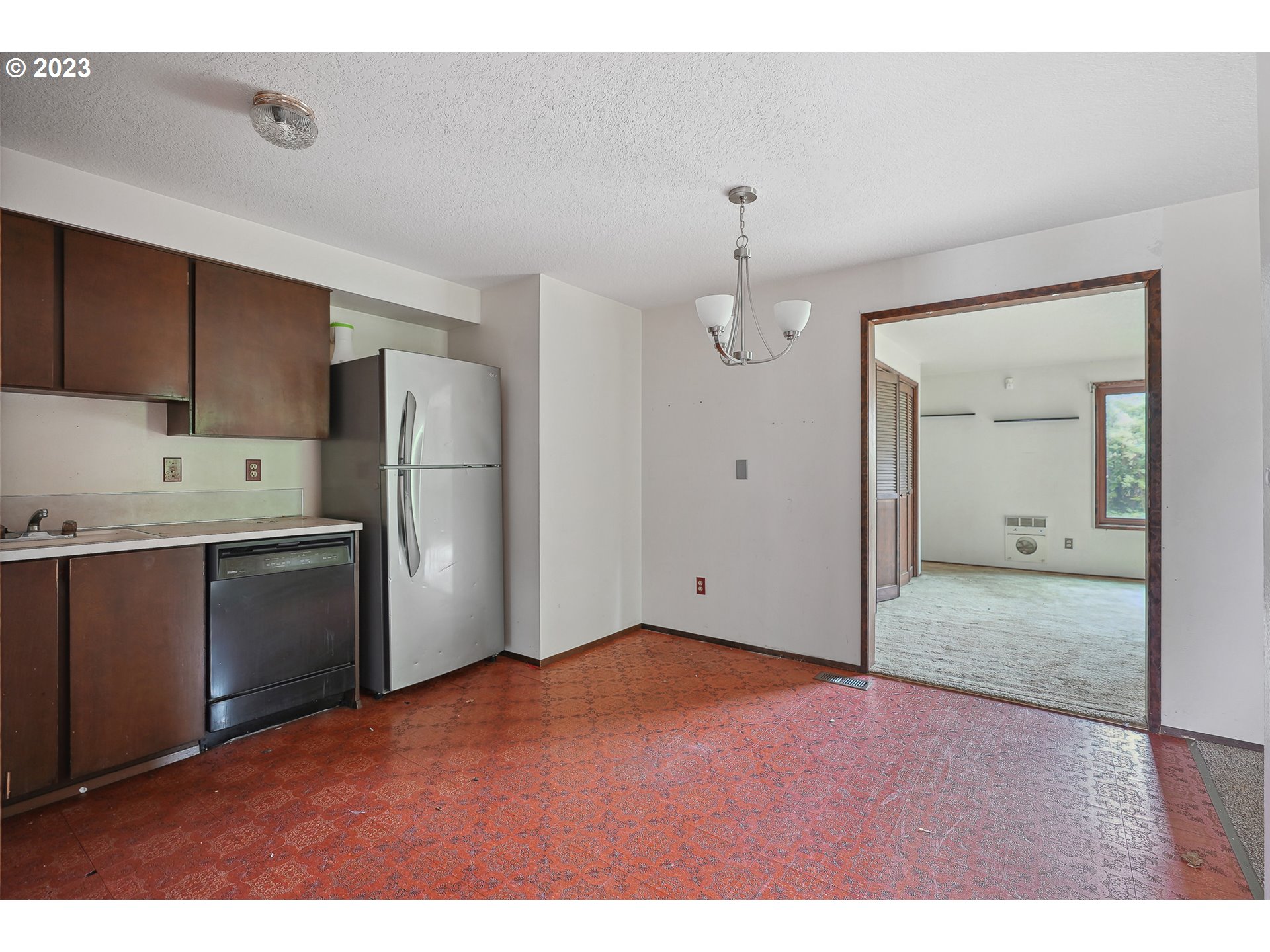 2295 Northeast Juniper Avenue Gresham, OR 97030 - Photo 9 of 25 a view of kitchen with refrigerator cabinets and wooden floor