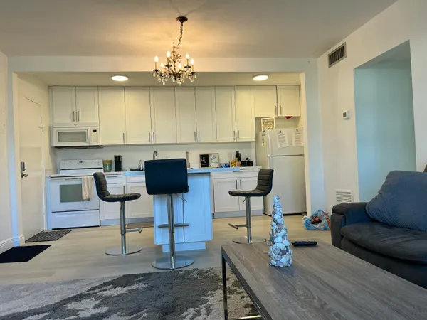 a view of kitchen with dining table and chairs
