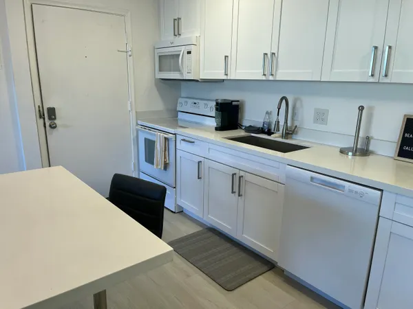 a kitchen with stainless steel appliances a refrigerator sink and cabinets