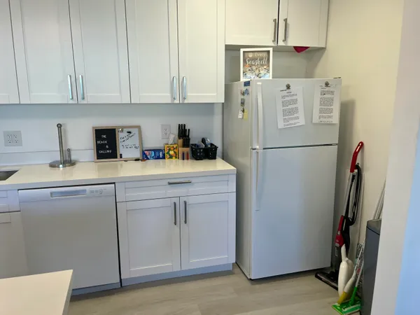 a white refrigerator freezer sitting in a kitchen