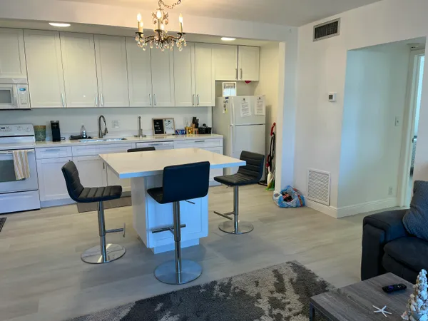 a kitchen with refrigerator and cabinets