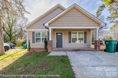 100 Henson Street Albemarle, NC 28001 - Photo 1 of 24 a view of a house with a yard and sitting area