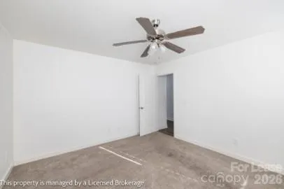 a view of a room with a ceiling fan