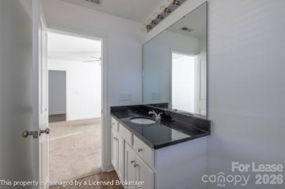 100 Henson Street Albemarle, NC 28001 - Photo 15 of 24 a bathroom with a sink and a mirror
