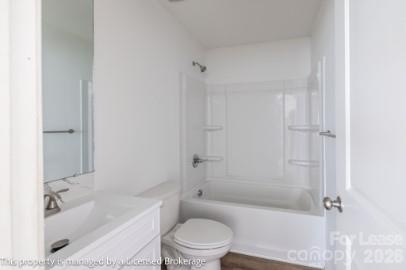 100 Henson Street Albemarle, NC 28001 - Photo 18 of 24 a bathroom with a bathtub shower sink vanity and toilet