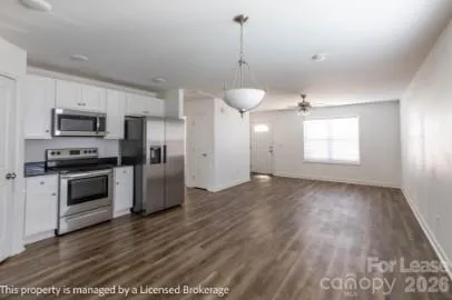 a view of a kitchen with a sink dishwasher stove and refrigerator