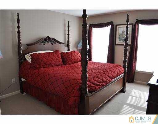 24 Sunflower Road Somerset, NJ 08873 - Photo 12 of 15 a bedroom with a bed and wooden floor