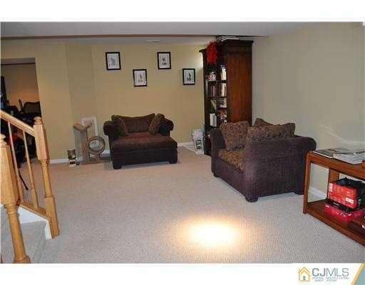 24 Sunflower Road Somerset, NJ 08873 - Photo 13 of 15 a living room with furniture and a flat screen tv