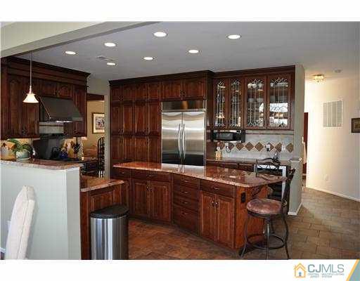 24 Sunflower Road Somerset, NJ 08873 - Photo 4 of 15 a kitchen with stainless steel appliances granite countertop a sink stove and refrigerator
