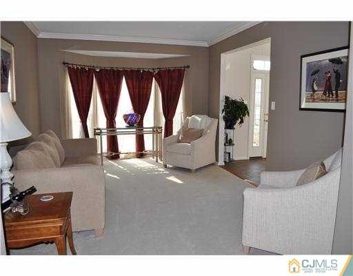 24 Sunflower Road Somerset, NJ 08873 - Photo 7 of 15 a living room with furniture and a window