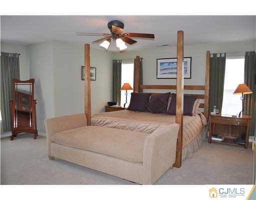 24 Sunflower Road Somerset, NJ 08873 - Photo 9 of 15 a bedroom with a bed and a chandelier