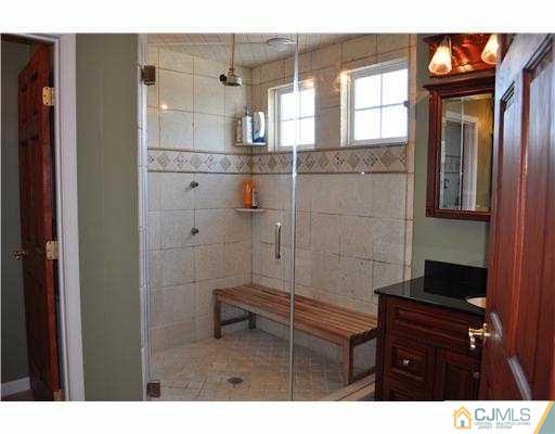 24 Sunflower Road Somerset, NJ 08873 - Photo 10 of 15 a bathroom with a sink a toilet and shower