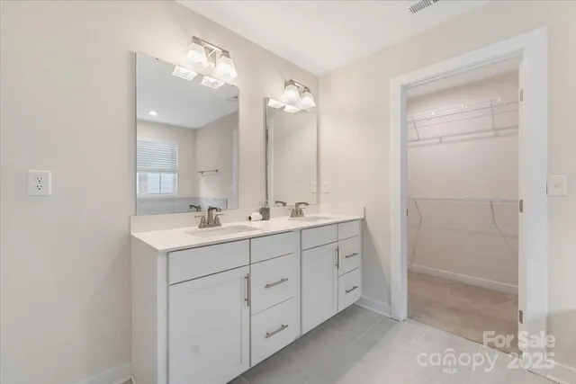 a bathroom with a double vanity sink mirror and double