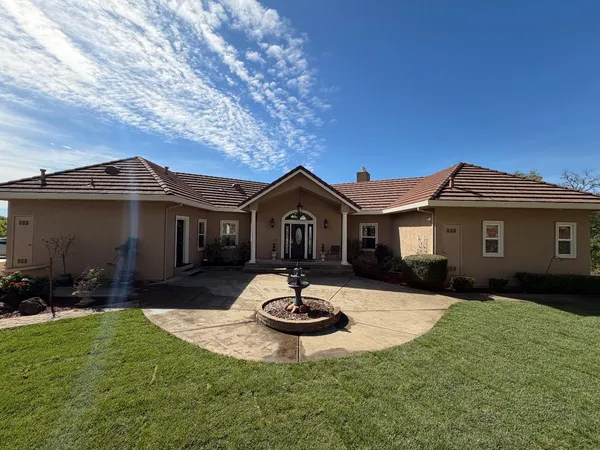 a front view of a house with fire pit