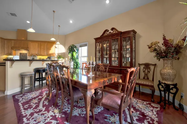 a living room with furniture floor to ceiling window and a flat screen tv