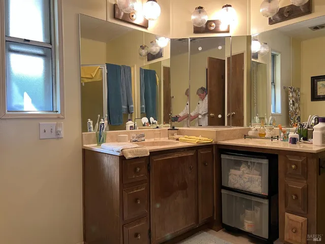 a bathroom with a double vanity sink and a mirror