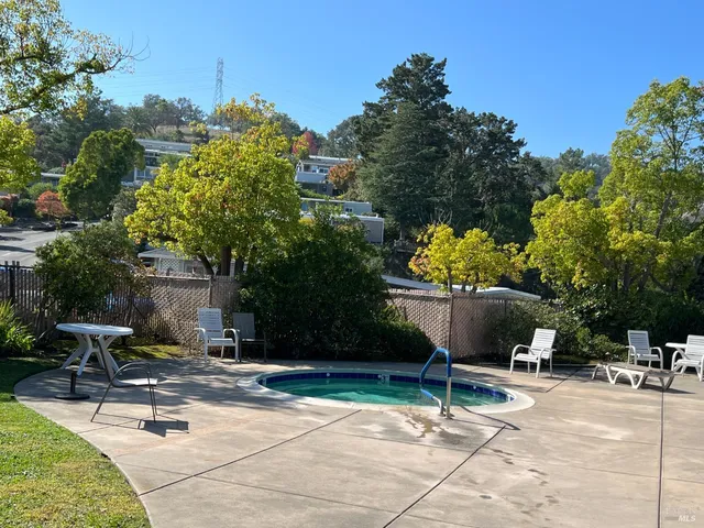 a view of a backyard with sitting area