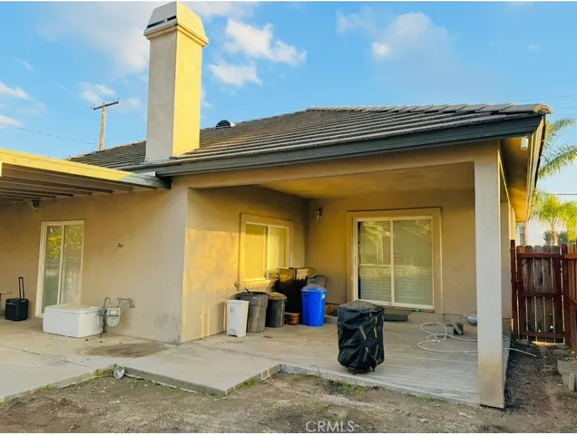 a view of a patio with table and chairs
