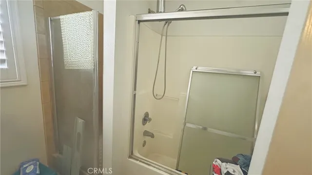 a bathroom with a glass shower door